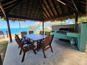 Seating area under a cabana in the Deluxe Bungalow with a BBQ